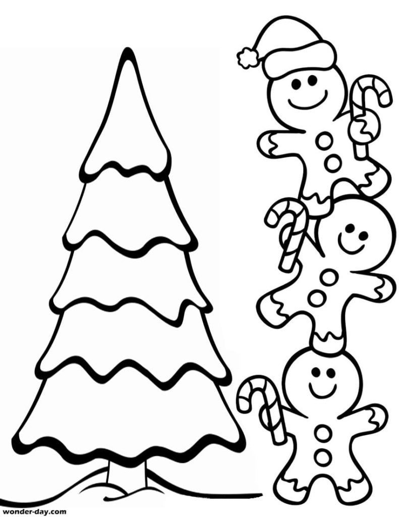 Hombres de pan de jengibre cerca del árbol de Navidad