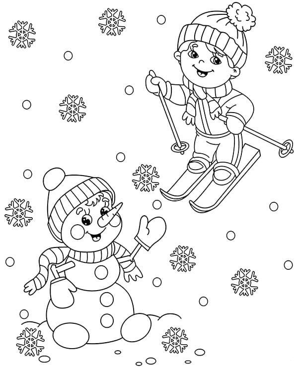 El niño y el muñeco de nieve se regocijan con la primera nevada.